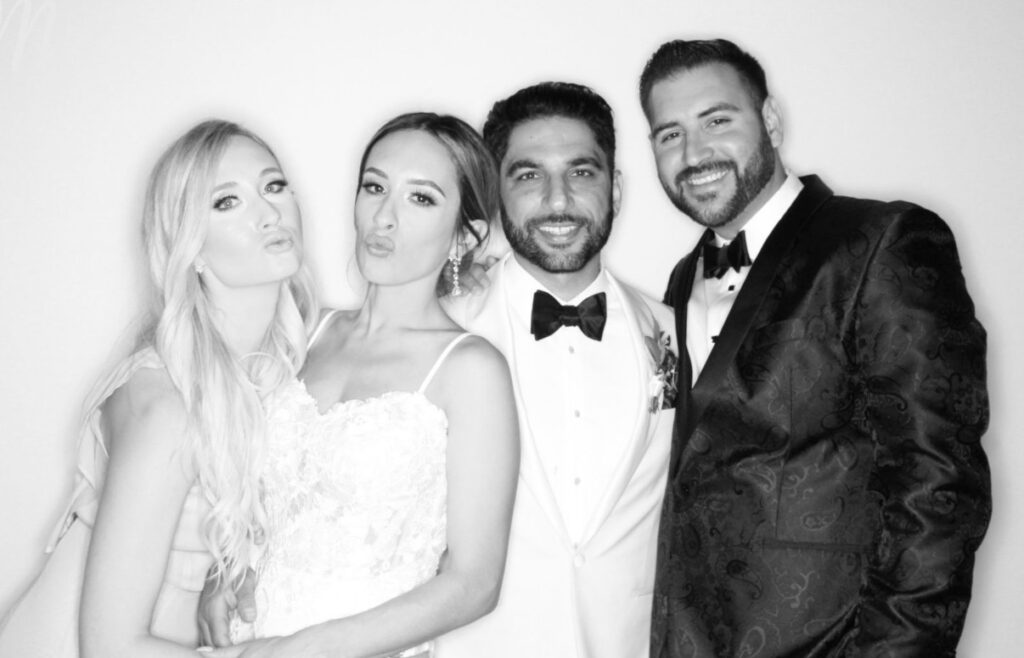 Guests posing together in a black-and-white Jump King Glam Photo Booth portrait