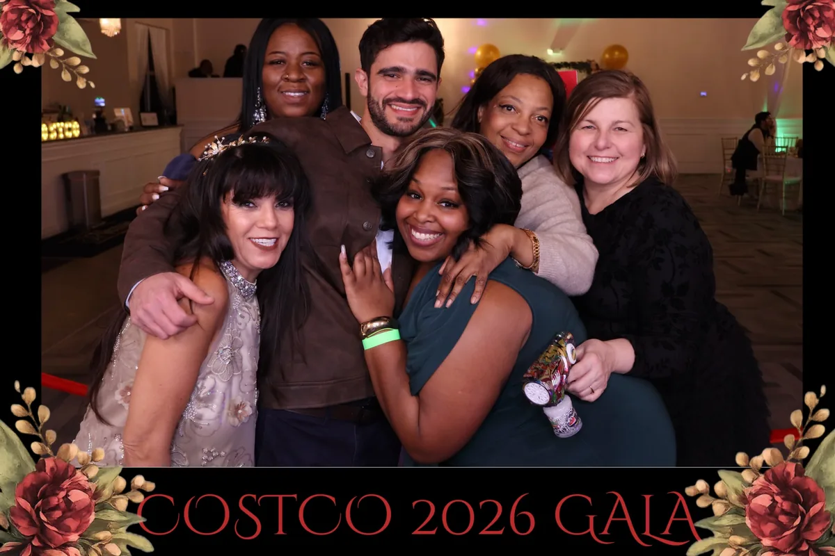 Guests smiling together in a Jump King photo booth at a gala